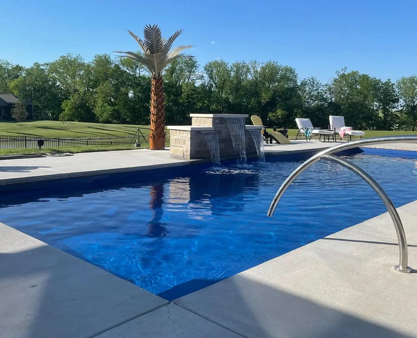 custom designed swimming pool with water feature installed - Columbia IL