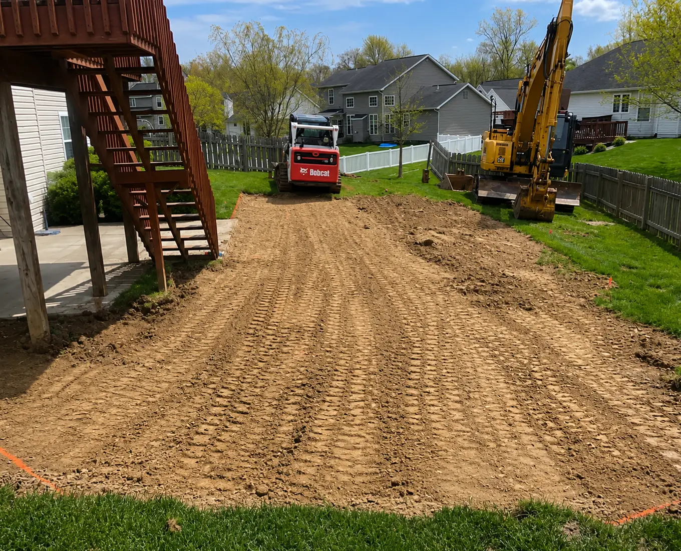Residential grading contractor in Columbia, IL leveling a backyard for drainage improvements and outdoor construction projects.