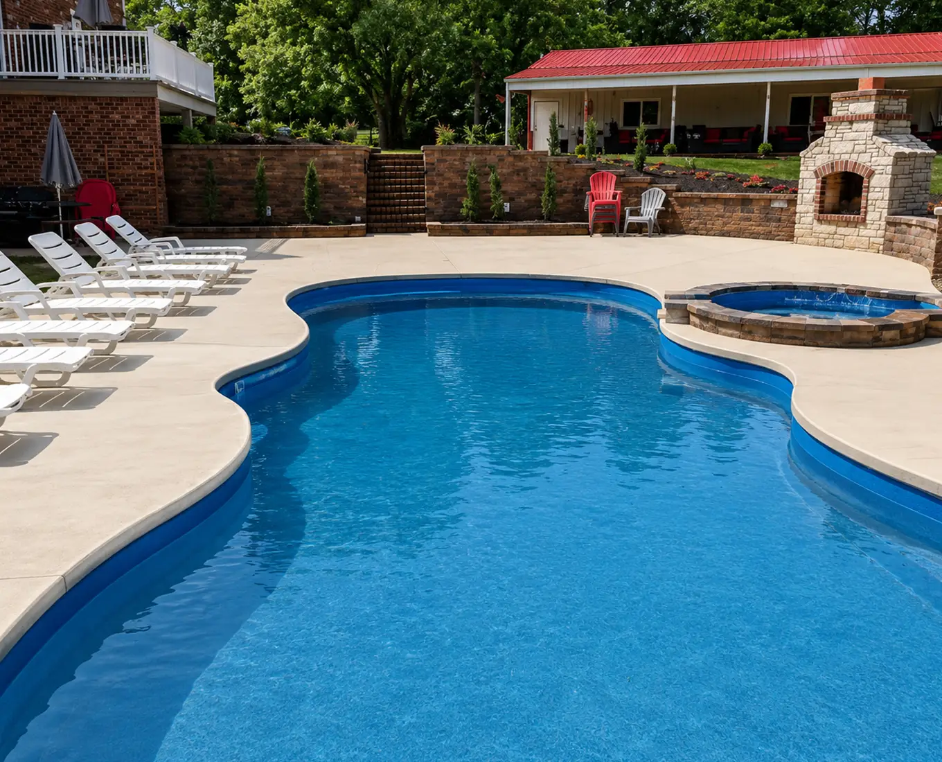Custom fiberglass pool with attached spa, outdoor fireplace, and spacious patio in Columbia, Illinois.