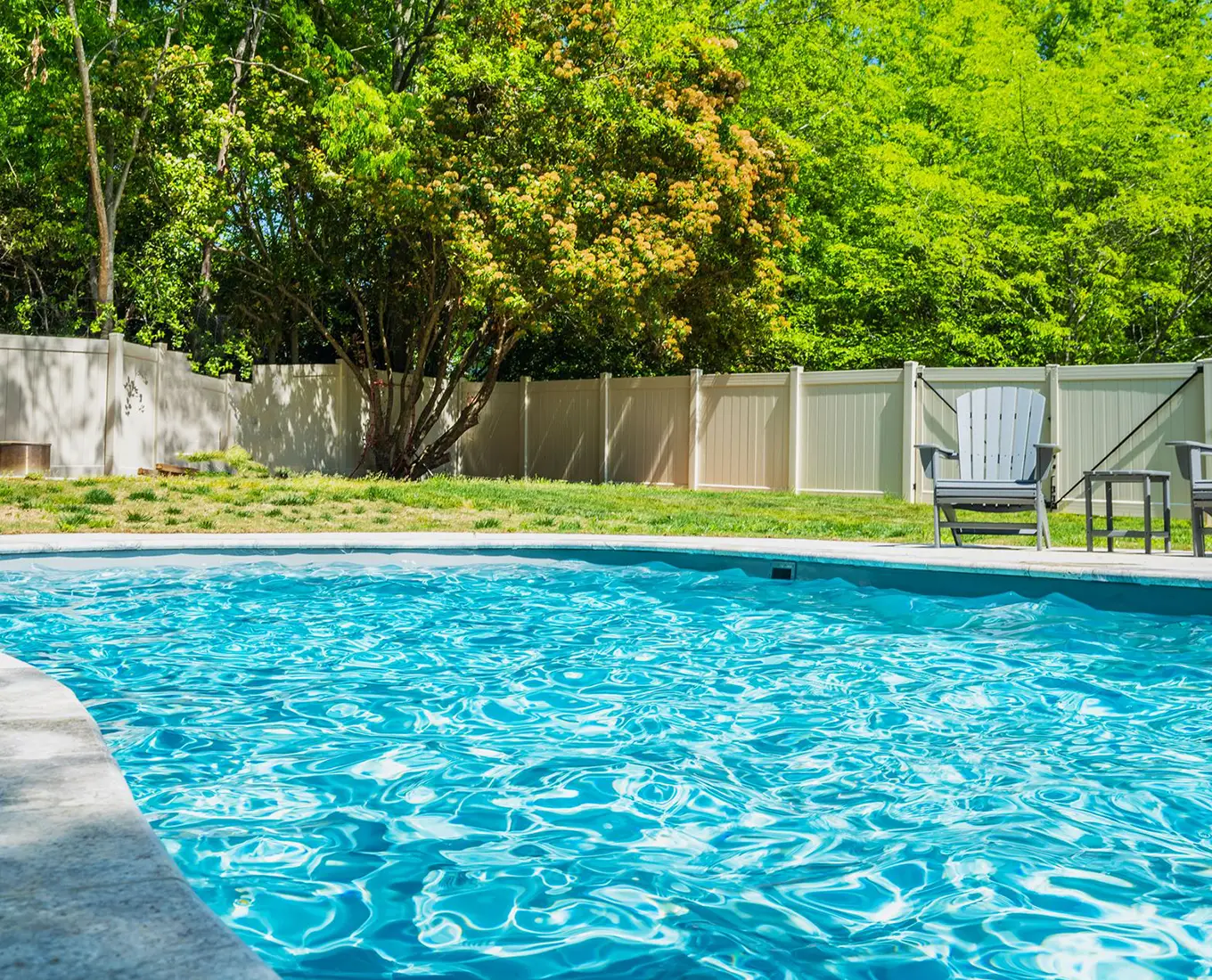 River Pools swimming pool installation creating a functional and attractive backyard escape for homeowners in Smithton, IL.