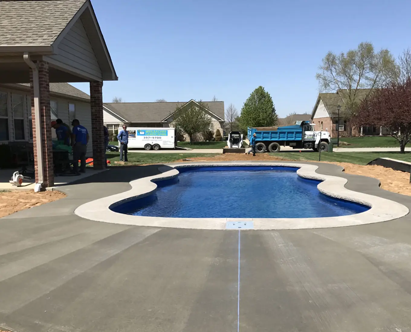 Recently completed pool construction project showcasing a fiberglass pool, finished decking, and expert craftsmanship in Waterloo, IL.
