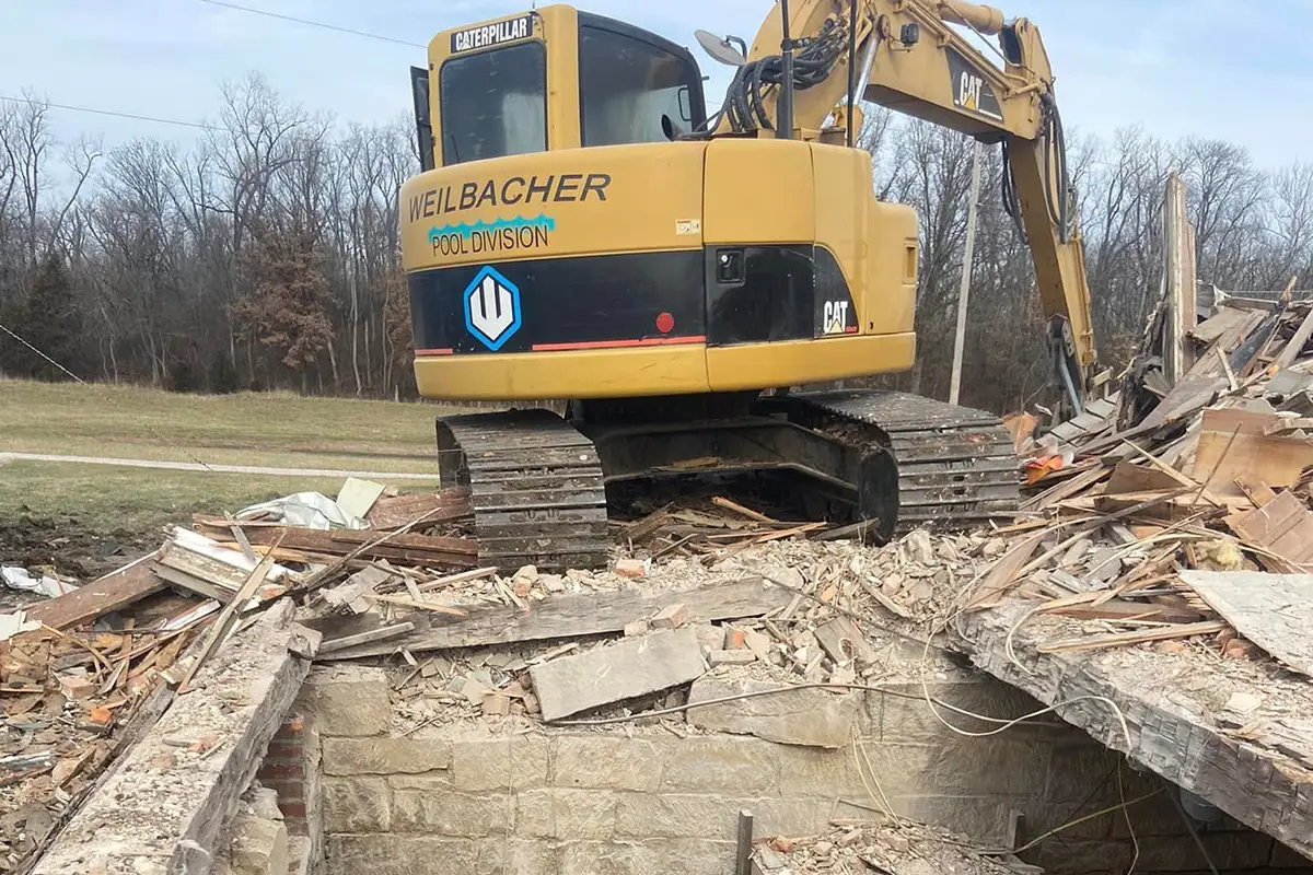 Weilbacher excavator clearing demolition debris at a residential site in Columbia, IL.